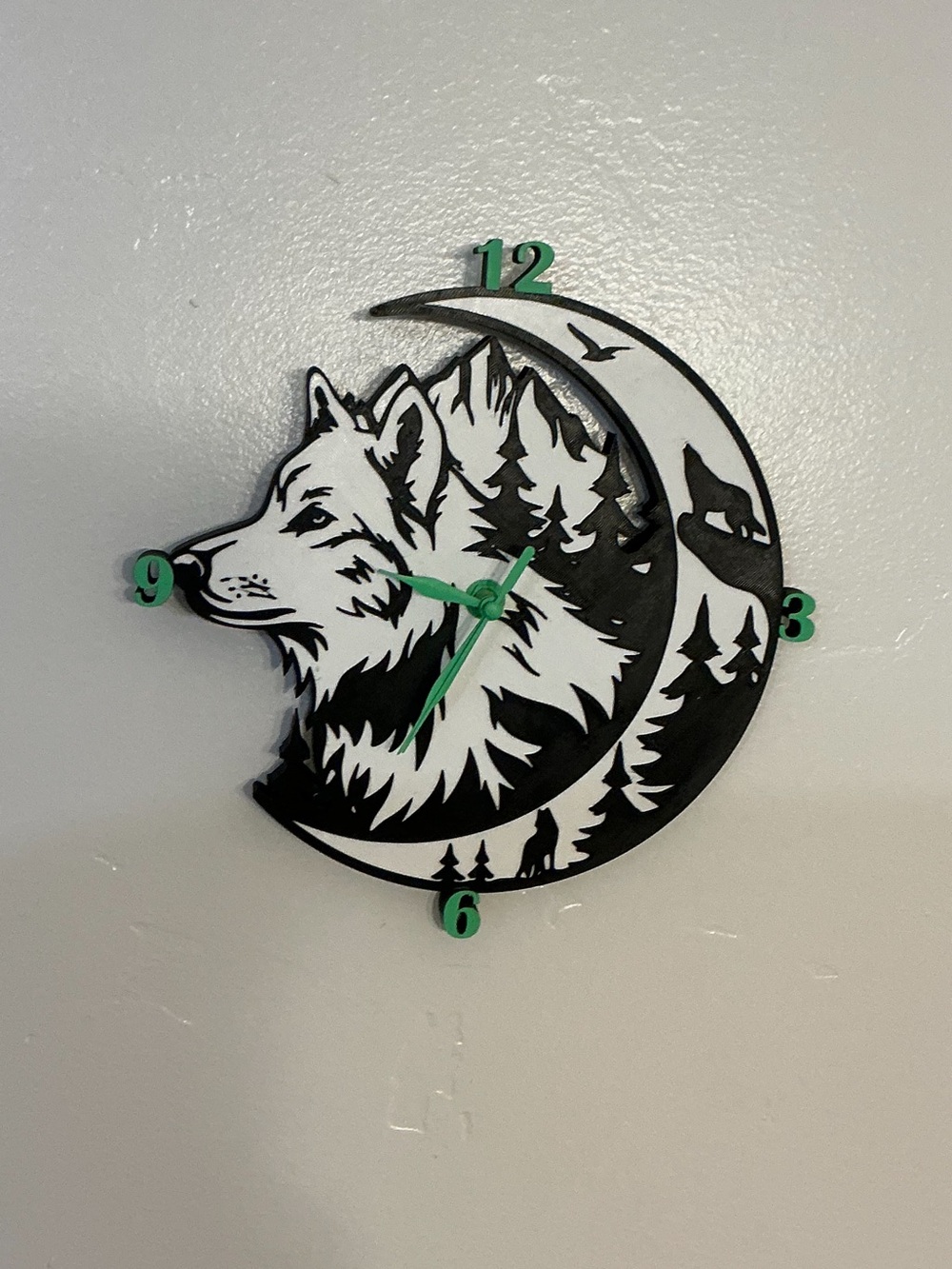 Wolf Moon Black and White Wall Clock with Green Accents